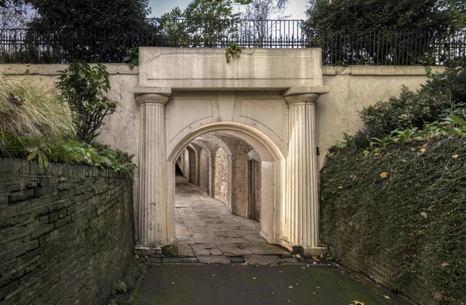 A photograph of a pedestrian subway with an ornate entrance with columns.