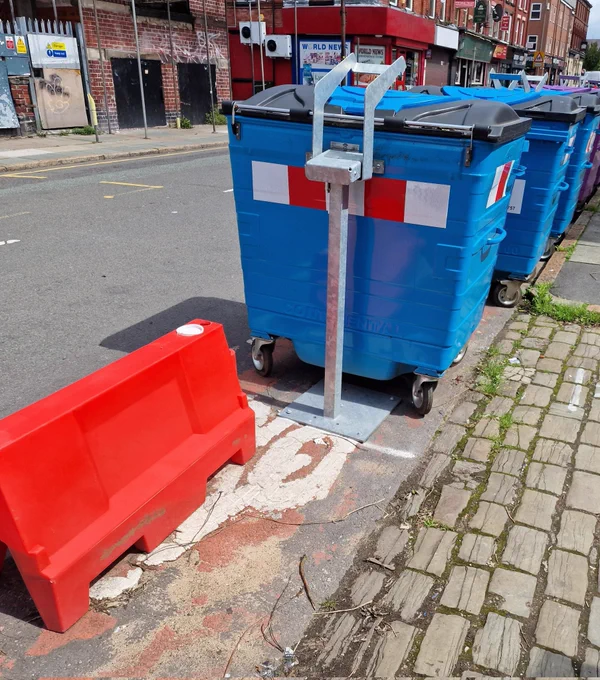 Blue community recycling bins installed in a cycle lane on Lawrence rd
