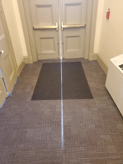 The same double doors and shaft of light seen head on.