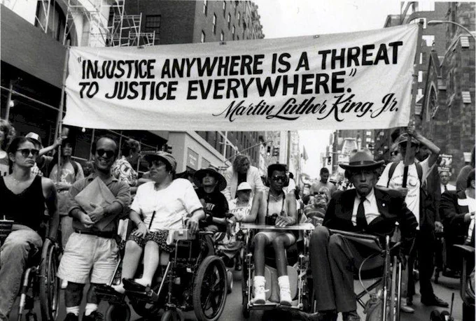 Image: Disability rights activists march down Madison Avenue in New York in 1993 Credit: Photo by Tom Olin