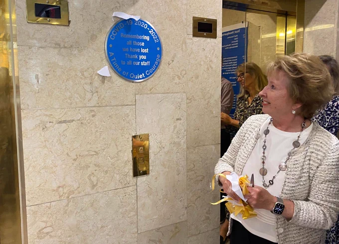 Chair Eileen Taylor looking at the Covid remembrance plaque.