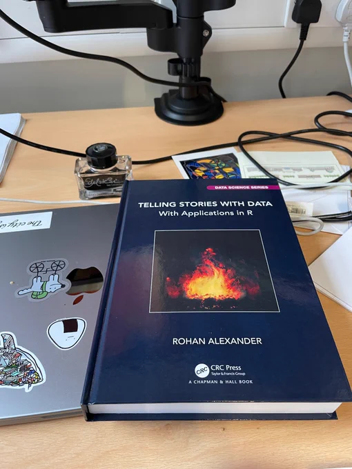 Photo of the book Telling Stories with Data on a desk