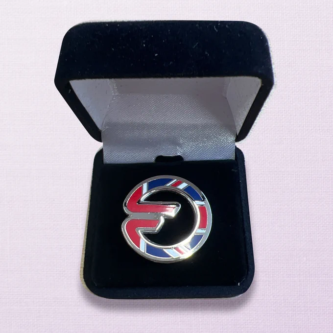 Picture of Orbit Fab icon-shaped pin with UK flag design on it.