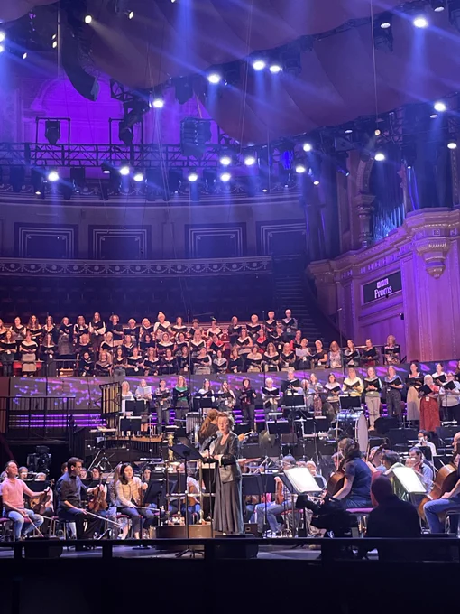 Lesley Manville standing on the Royal Albert Hall stage with the BBC Symphony Orchestra and Chorus and BBC Singers, taken during rehearsal earlier in the day. 