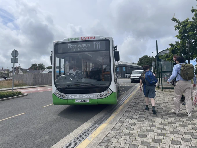 A photo of YJ56 WUH, an Optare Tempo branded for TrawsCymru Connect, running on the T11 to Haverfordwest via St David's. Taken at Fishguard "bus station".