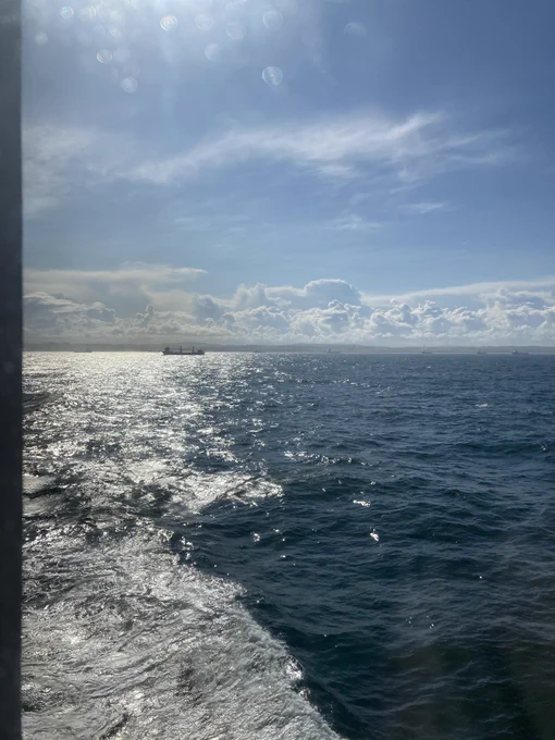 Foam-capped sea in the sun’s glitter
