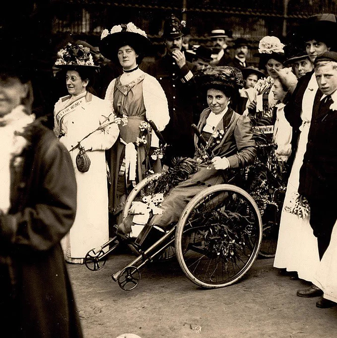 Rosa May Billinghurst in a wheelchair surrounded by a group of women