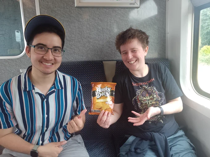 DAX (left) and ELL (right) with a snack on the train, copying The Snack Zone (from Jet Lag: The Game).