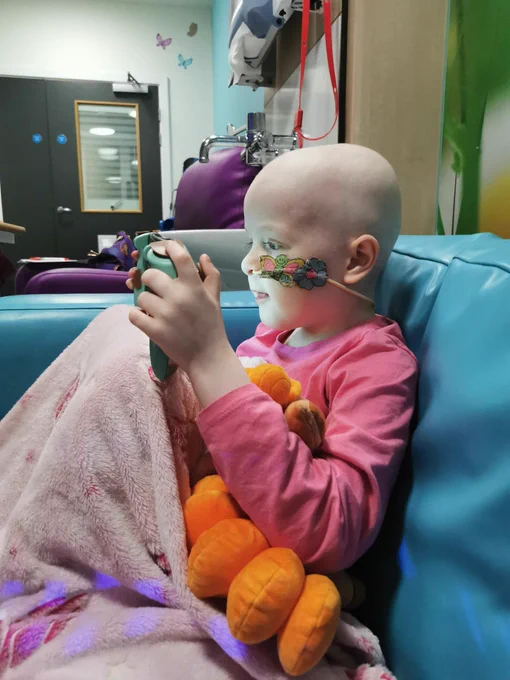 Child playing video game whilst getting chemotherapy
