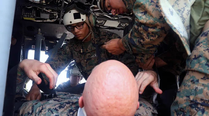 U.S. Navy Sailors with Combat Logistics Battalion 8 (CLB-8), Combat Logistics Regiment 2 (CLR-2), 2nd Marine Logistics Group (2nd MLG), strap a simulated casualty securely during a simulated medical evacuation exercise for UNITAS LXIV in Cartagena, Colombia, July 14, 2023. (U.S. Marine Corps photo by Lance Cpl. Mary Kohlmann)