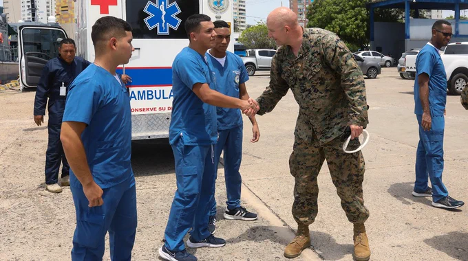 U.S. Navy Chief Hospital Corpsman Jonathan Bootan with 3rd Battalion, 23rd Marines, 4th Marine Division, shakes hands with Colombian Navy medical personnel, during a simulated medical evacuation exercise for UNITAS LXIV in Cartagena, Colombia, July 14, 2023. (U.S. Marine Corps photo by Lance Cpl. Mary Kohlmann)