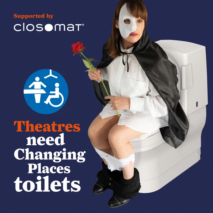 Female on Closomat Wash-Dry toilet as Phantom of the Opera, white pants & black trousers around lower leg, holding Red rose. Text: Supported by Closomat, Theatres need Changing Places toilets. 