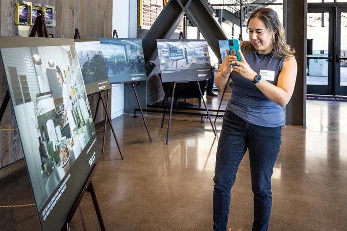 Marissa Sanchez, a third-year food and nutrition entrepreneurship student and a member of the current Veterans Imagination Project cohort, takes a picture of her imagined future during the Future Visions showcase.