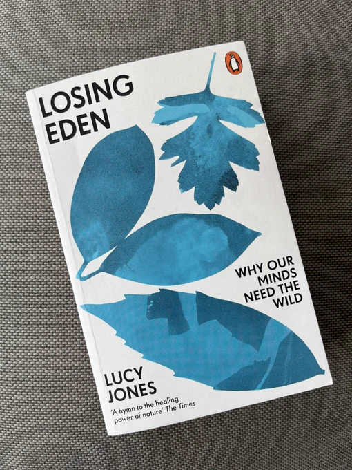 A copy of the book Losing Eden: why our minds need the wild, by Lucy Jones. The book is white with a blue leaf pattern on the front.