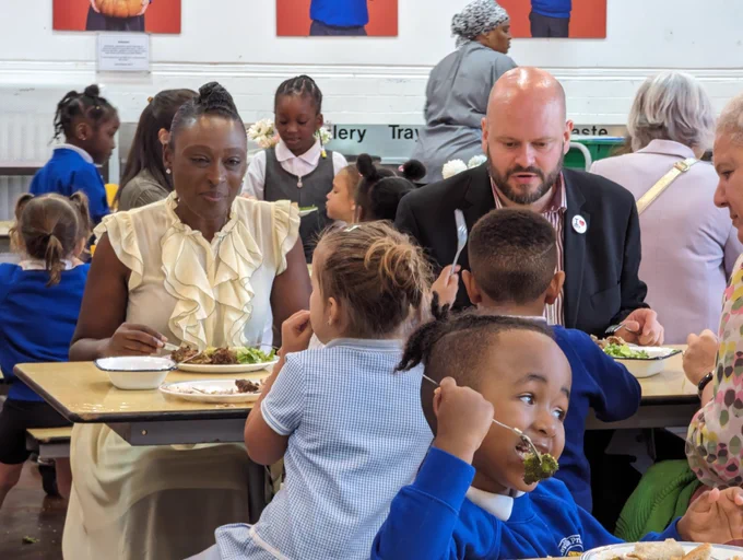 Council leading and schoolchildren having lunch