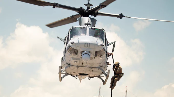 A Peruvian Marine conducts fast rope operations from a U.S. Marine Corps UH-1Y Venom during helicopter rope suspension tactics training for UNITAS LXIV at Cartagena, Colombia, July 13, 2023. (U.S. Marine Corps photo by Sgt. Colton K. Garrett)