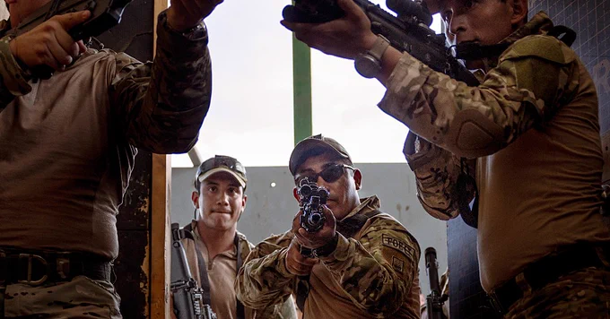 Peruvian Marines clear a room during visit board search and seizure training during UNITAS LXIV at Cartagena, Colombia, July 12, 2023. During UNITAS, reconnaissance and special operation force Marines and sailors from 11 partnered and allied nations conducted multilateral special operations training consisting of fast roping, room clearing, VBSS, jungle patrolling, low level static line jumping, and small arms tactics. (U.S. Marine Corps photo by Sgt. Colton K. Garrett)