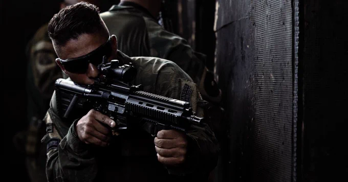 A Brazilian Marine provides rear security during visit board search and seizure training during UNITAS LXIV at Cartagena, Colombia, July 12, 2023. During UNITAS, reconnaissance and special operation force Marines and sailors from 11 partnered and allied nations conducted multilateral special operations training consisting of fast roping, room clearing, VBSS, jungle patrolling, low level static line jumping, and small arms tactics. (U.S. Marine Corps photo by Sgt. Colton K. Garrett)