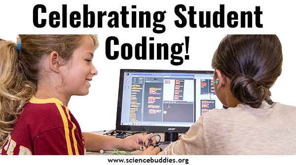 Two students at a computer working on a coding project