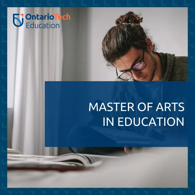A person with curly brown hair tied up in a bun, black-framed glasses, and an olive green hoodie is reading a book. The text overlay reads, "Master of Arts in Education.."