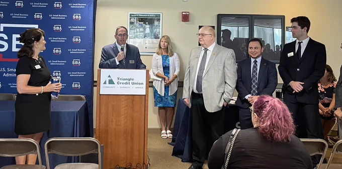 Persons from Triangle Credit  standing  and talking