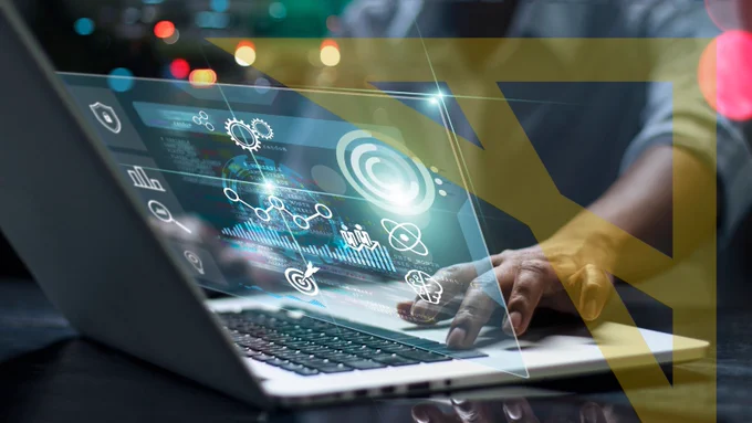 A person using a computer with the Alliance's arrow logo on the image.