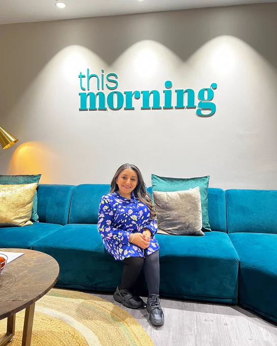 Shani, a South Asian disabled woman sitting on a sofa in the This Morning Studio’s green room.