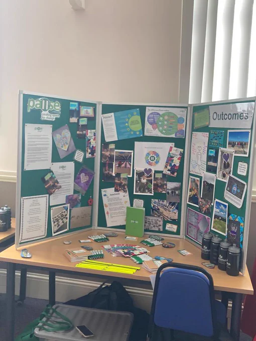 Close up picture of a board. The board has lots of pictures and information about Pause in the Halton and Knowsley area. On the table you can see leaflets that explain the Pause service
