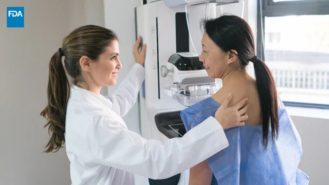 Woman and health care provider during a mammogram screening.