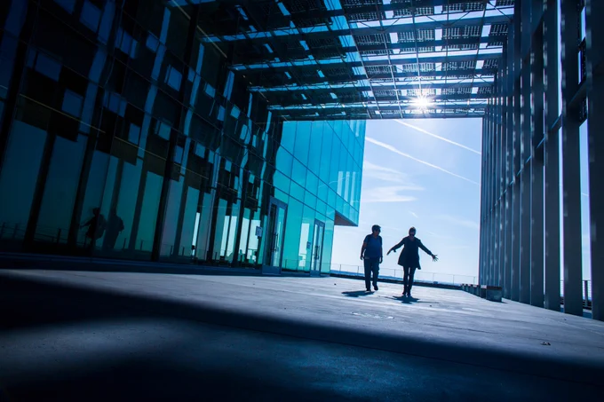 Two people walking under solar panels at UC Merced