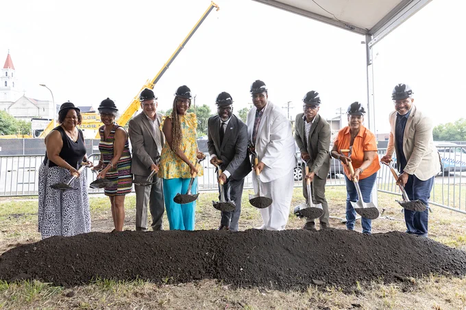 Photo ID: Mayor Johnson and group lift dirt with their shovels. 