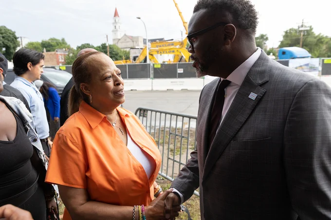 Photo ID: The mayor shakes hands with an individual.