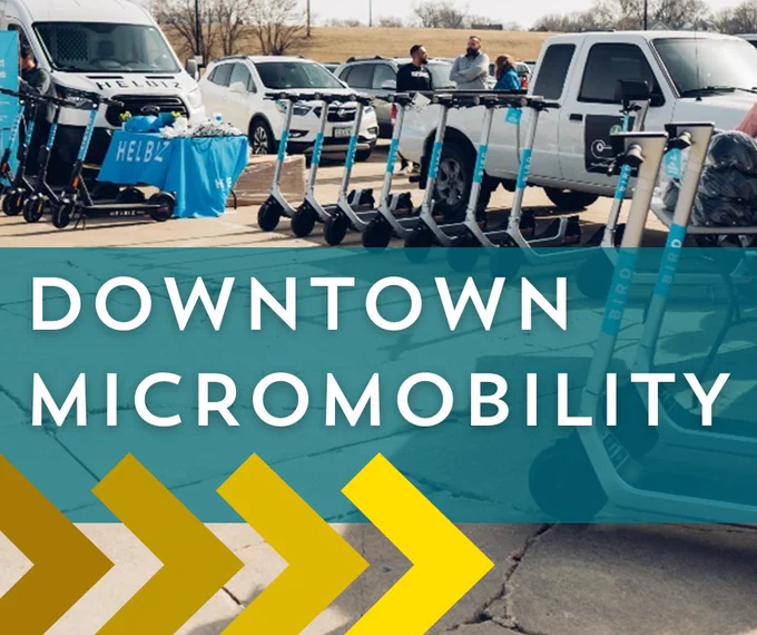 E-scooters lined up for a launch event. Overlaid text says downtown micromobility.
