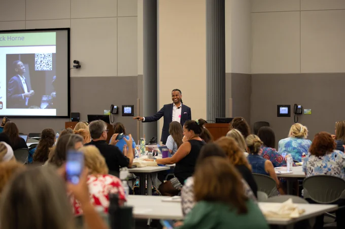 Keynote speaker LeDerick Horne addresses a room full of educators at the 2023 Special Programs Summer Conference — Recharge: Jump Start Your School Year.