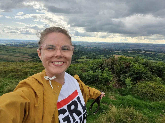 Bobi smiling on top of a hill in the Shropshire hills.