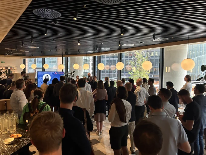 A room full of people listening to a talk
