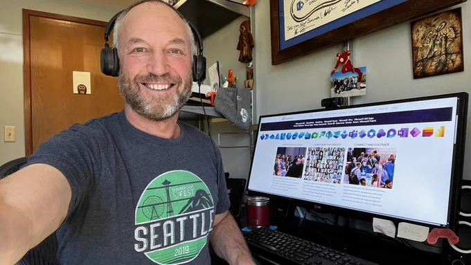 Mark Kashman taking a selfie wearing an old 2019 SP Fest Seattle t-shirt in front of his computer with the 365 EduCon website showing; #SWAGPast