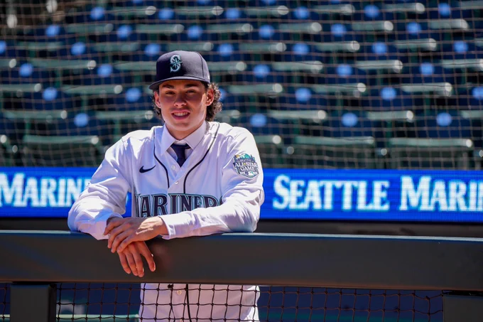 Photo of Jonny Farmelo standing on the edge of the dugout before taking batting practice. 