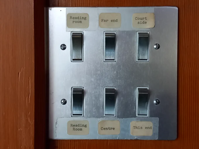 The image shows a panel of light switches for the upper floor of the library
