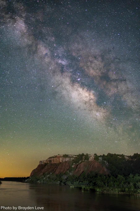 The sky expands over the dark waters of the Cimarron River. In the middle of nowhere, you can see the galaxies. The Milky Way unfolds over the red cliffs of Westen Oklahoma. 