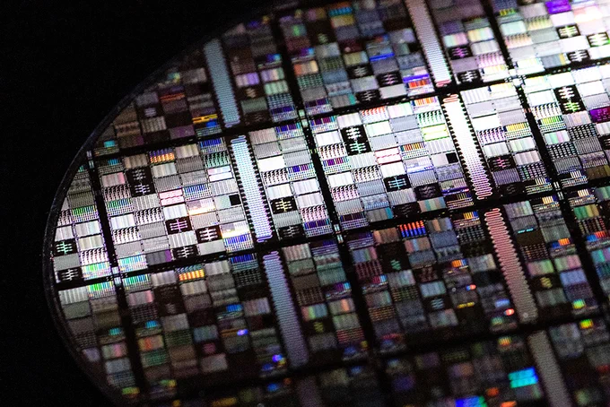 A close-up shot of a superconducting qubit wafer, showing microfabricated circuits.