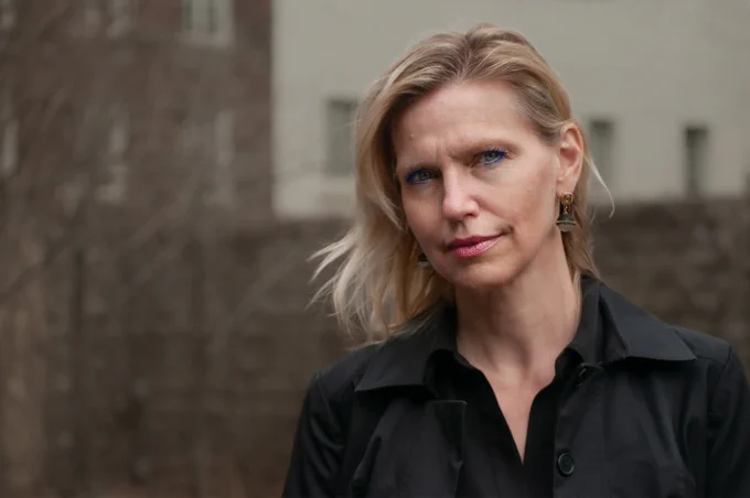 author photo: Carolyne Van Der Meer. She is a white woman with shoulder-length blonde hair. She is outdoors and stands outside a building (blurred) in the background. She smiles a the camera.