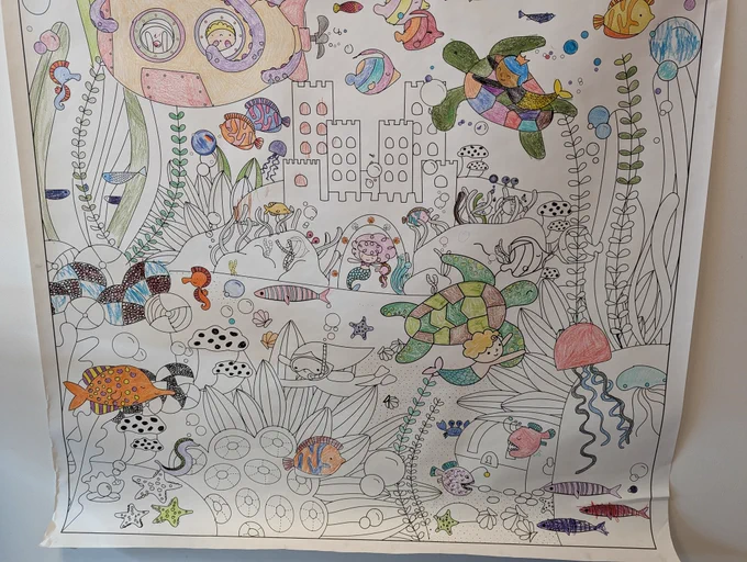 The bottom section of the colouring sheet just inside the doors of the Charles Hall Library. This section is only partially coloured, and features lots of sea creatures, a castle, and lots of underwater plants. 