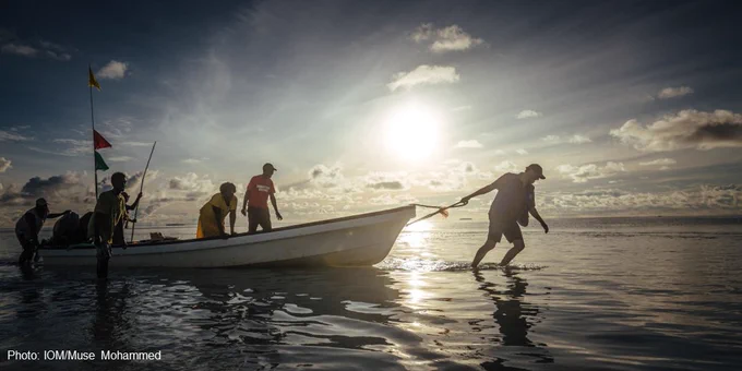 A man pulls a boat on the low-lying Carteret Islands in Papua New Guinea. 