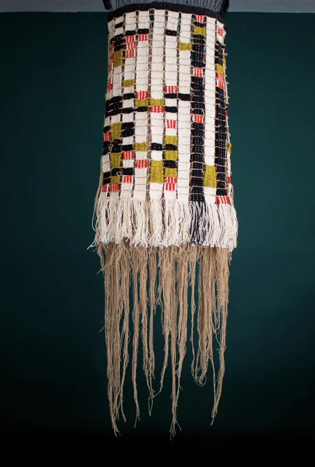 Hanging textile that matches the previous sketch (grid with different-colored hatching) with hanging tendrils resembling a jellyfish.