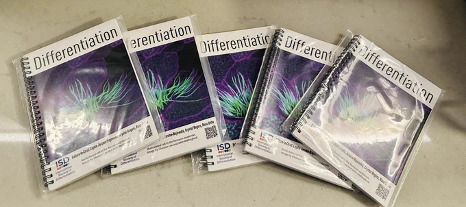 Stack of white notebooks with a beautiful image from the Wallingford Lab.