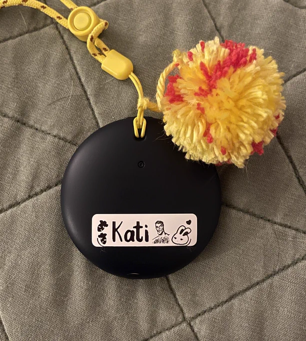 Pokémon Go Plus   with name label and red and yellow Pom Pom