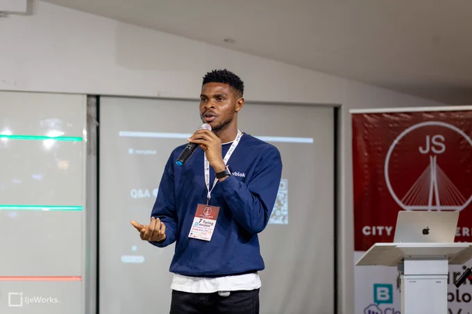 Fortune Ikechi, holding a mic and speaking to the attendees