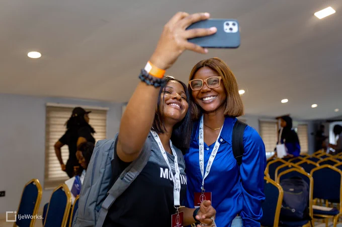 Ruth Ikegah and an attendee at CityJS Conference 2022 taking a selfie and smiling into the camera.