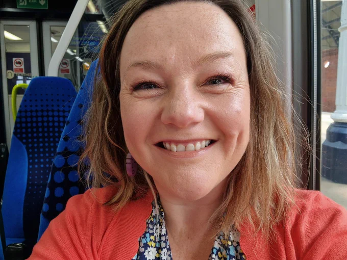 An incredibly smiley Lisette because she's on a train 